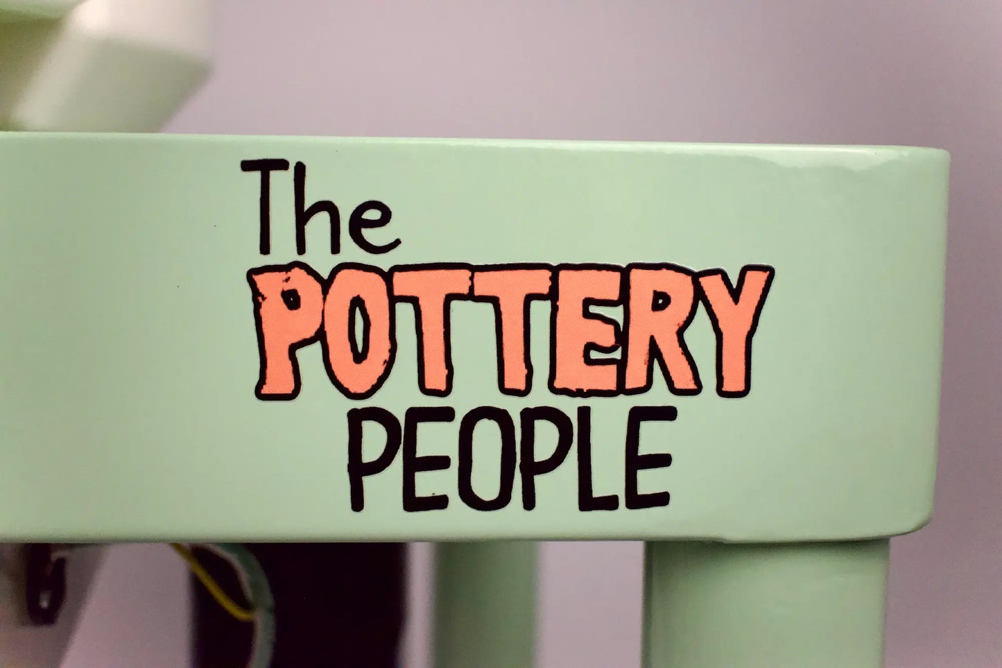 The Pottery People Logo on pottery wheel
