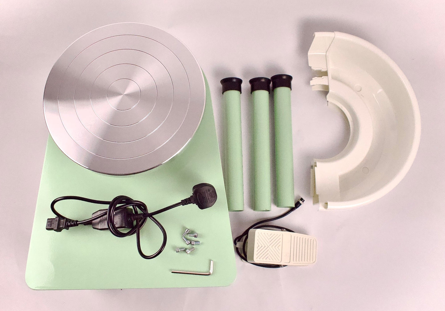 the home studio wheel disassembled and laid out on the ground 